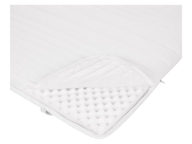 Matelas blanc avec fermeture éclair, montrant l'intérieur en mousse.