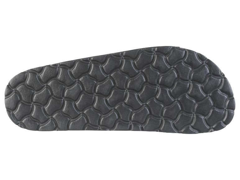 Semelle de sandale noire avec motif texturé.