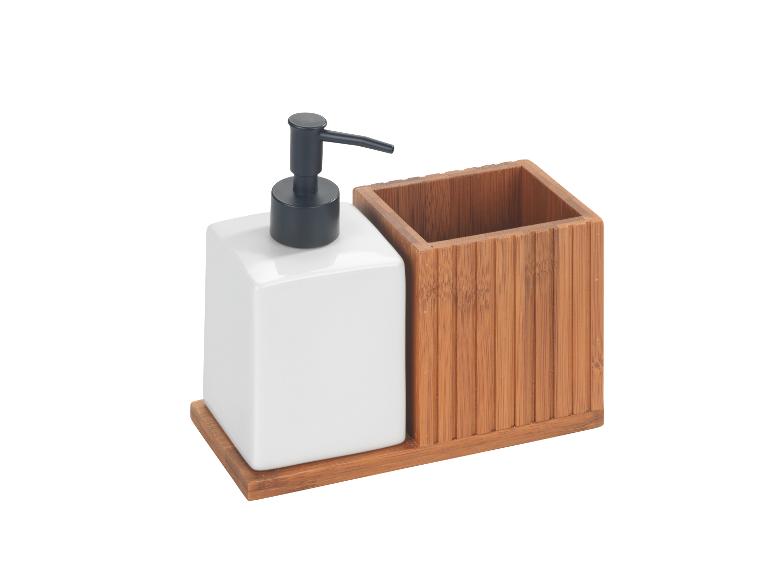 Distributeur de savon et porte-brosses à dents en céramique blanche et bambou.