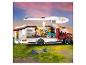 Camping-car Lego avec toit et côté ouverts, montrant l'intérieur avec deux figurines.
