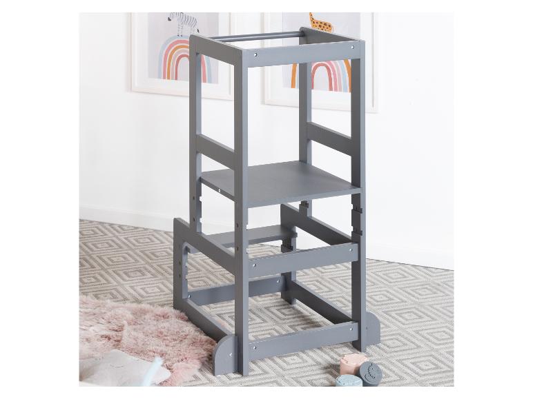 Tour d'apprentissage en bois gris pour enfants avec étagères réglables, sur un tapis à motifs géométriques