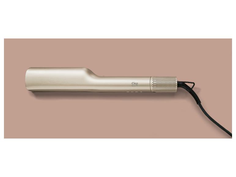 Lisseur doré Cien Beauty avec un cordon noir sur fond rose