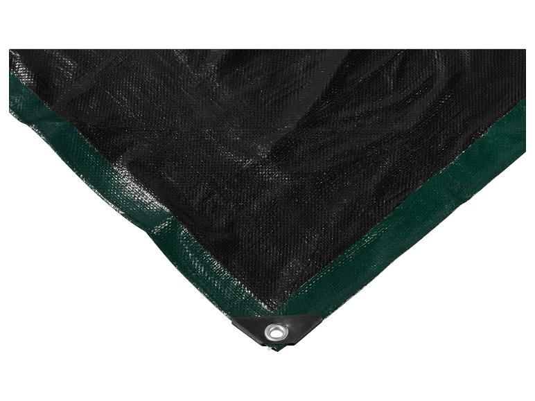 Gros plan d'une bâche noire avec une bordure verte et un œillet métallique dans le coin.