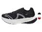 Chaussures de sport noires avec semelle blanche et détails gris.