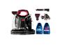 Nettoyeur Bissell MultiClean Spot & Stain avec divers accessoires et deux bouteilles de solution de nettoyage.