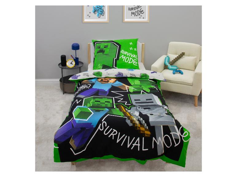 Parure de lit thème Minecraft avec oreiller vert et housse de couette noire, personnages et texte « SURVIVAL MODE ».