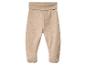 Pantalon de bébé beige avec pieds intégrés et taille élastique large