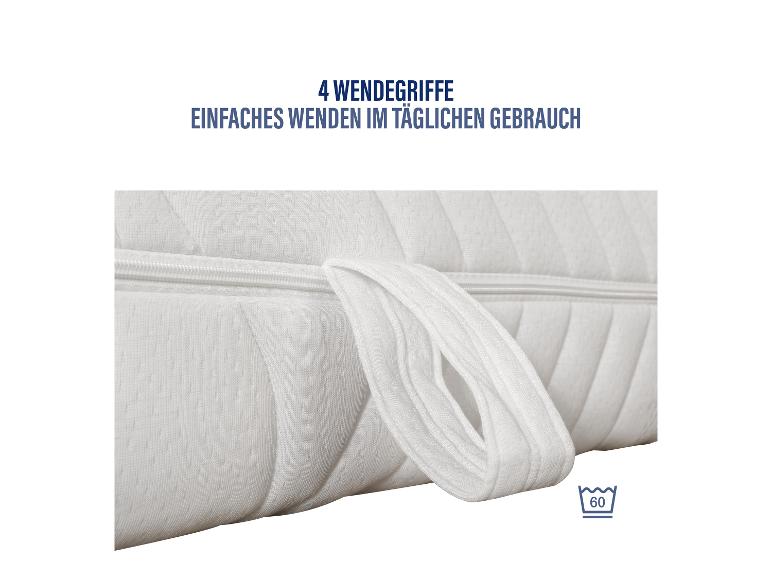 Gros plan sur un matelas blanc avec fermeture éclair et une boucle