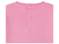 Le dos d'un t-shirt rose avec des boutons.
