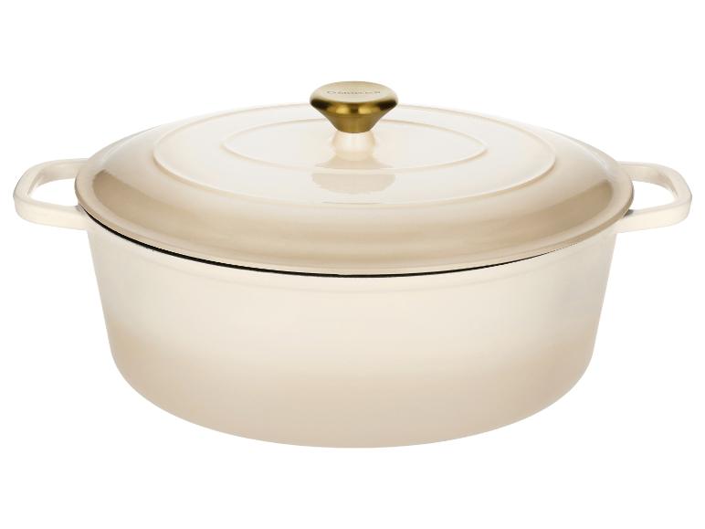 Cocotte en fonte émaillée couleur crème avec un bouton doré sur le couvercle.