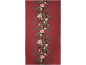 Nappe rouge avec une guirlande centrale de poinsettias, baies et branches de pin.