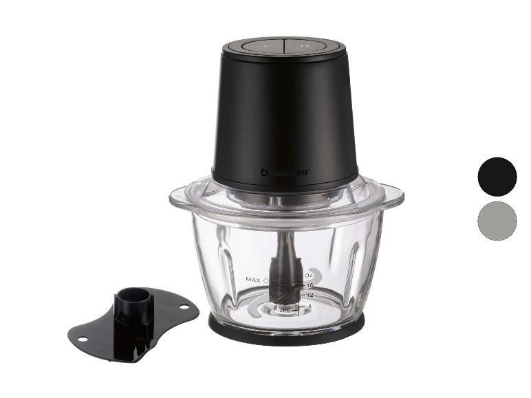 Hachoir noir avec un bol en verre et un accessoire supplémentaire, présenté sur fond blanc.