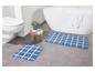 Deux tapis de bain à carreaux dans une salle de bain.