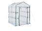 Serre de jardin transparente avec structure verte et étagères.