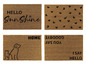 Quatre paillassons avec des designs différents: 'Hello Sunshine', des cœurs, 'Home' avec un chien et un chat et 'You Say Goodbye I Say Hello'.