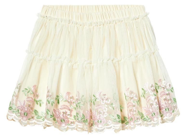 Une jupe en tulle crème avec des fleurs brodées roses et vertes.