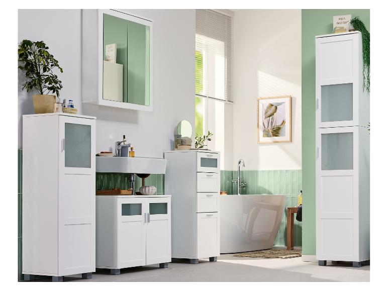 Salle de bain moderne avec meubles blancs, lavabo, baignoire et plantes décoratives.