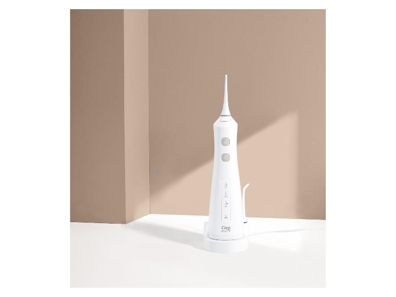 Hydropulseur blanc Cien Beauty sur une base de chargement, avec un fond beige
