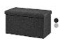 Un pouf de rangement en tissu gris foncé avec un dessus rembourré.