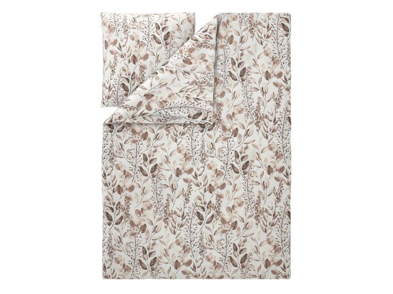 Parure de lit avec un motif de feuilles marron sur fond blanc.