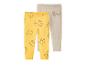 Deux leggings pour bébé, un jaune avec des visages d'ours et un gris avec des personnages de dessins animés.