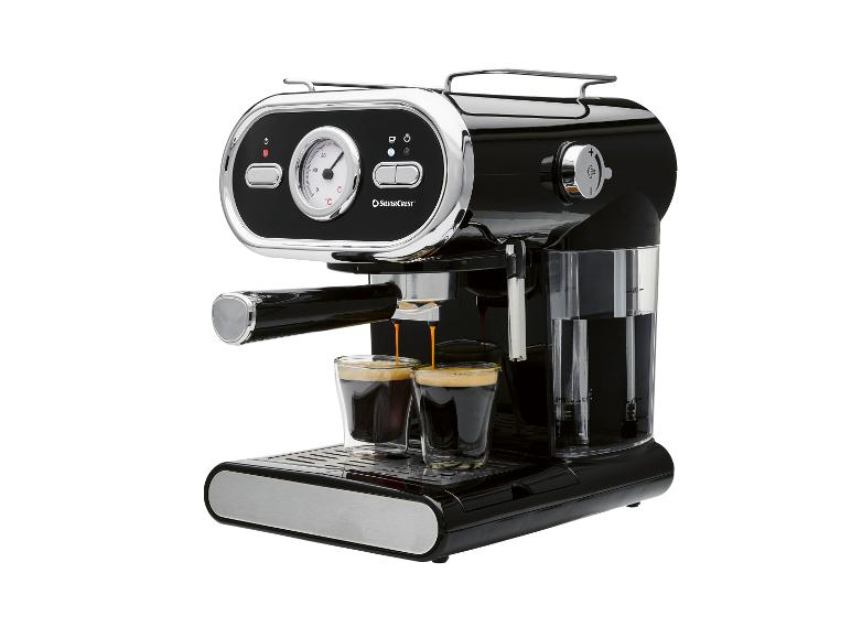 Machine à expresso noire avec des détails chromés, préparant deux cafés dans des tasses en verre.