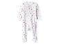 Pyjama blanc pour bébé avec étoiles roses et marron.