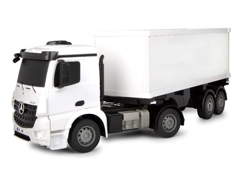 Modèle de jouet blanc d'un camion Mercedes Arocs avec une remorque blanche.