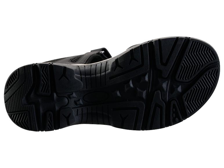 Semelle de sandale de sport noire avec motif d'adhérence.