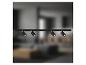 Système de spots sur rail noir BRILONER avec quatre spots orientables dans un salon.