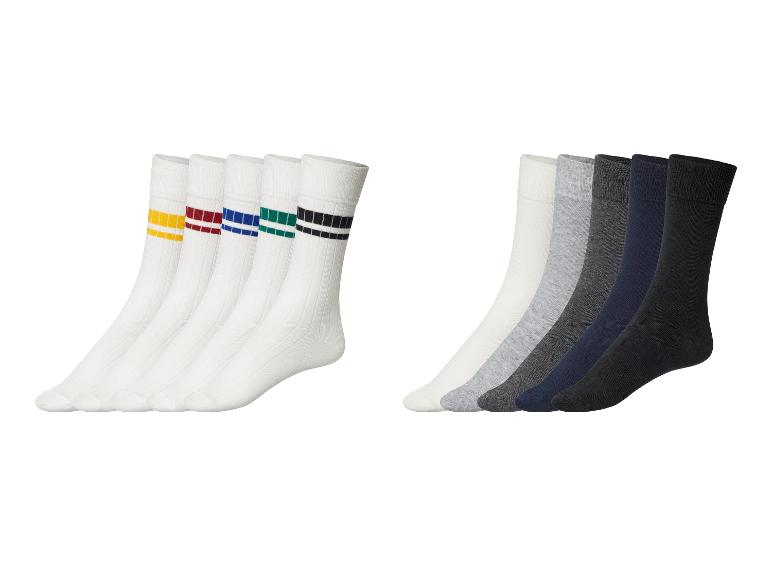 Des chaussettes blanches à rayures colorées et des chaussettes unies grises et noires.