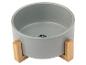 Bol en céramique gris pour chien sur un support en bois.