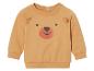 Pull beige pour bébé avec un motif d'ours.