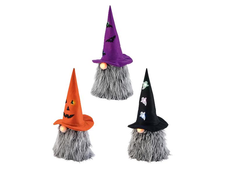 Trois gnomes décoratifs d'Halloween avec des chapeaux lumineux.