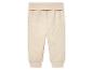 Pantalon bébé beige en tissu molletonné.