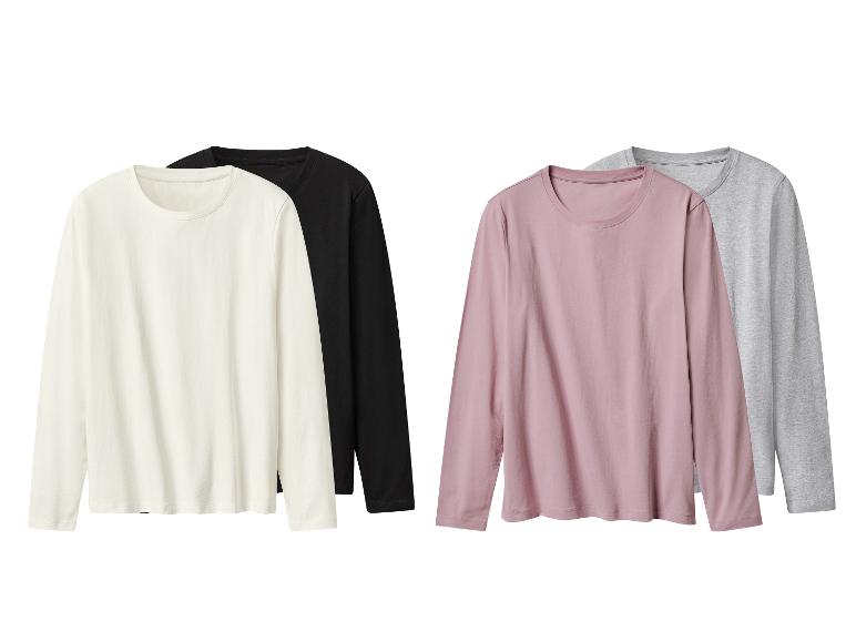 Quatre t-shirts à manches longues en blanc, noir, rose et gris.