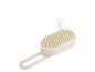 Brosse de massage du cuir chevelu beige avec vapeur.