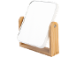 Miroir de table avec cadre blanc et support en bois.