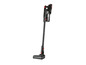 Un aspirateur sans fil noir et rouge avec lumière LED.