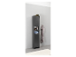 Une haute armoire de salle de bain gris foncé avec des étagères et une serviette accrochée au mur.