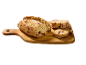 Tranches de pain rustique aux canneberges et noix sur une planche à découper en bois