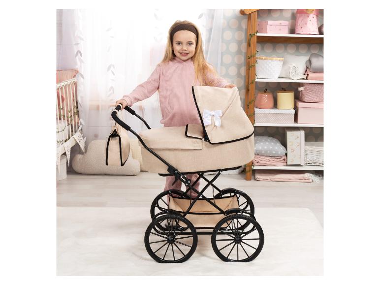 Fillette avec une poussette de poupée dans une chambre d'enfant.