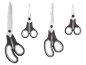 Quatre paires de ciseaux noirs et gris de différentes tailles sur fond noir.