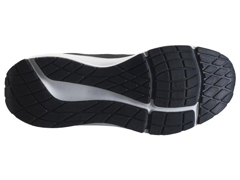 Semelle de chaussure de sport noire et blanche avec motif d'adhérence.