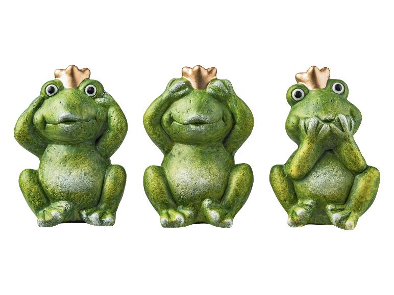 Trois grenouilles vertes avec des couronnes dorées qui adoptent la pose 'Je ne vois pas, je n'entends pas, je ne parle pas'.