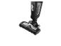Aspirateur balai sans fil noir et argenté avec réservoir sans sac visible.