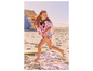 Une fille en robe de bain rose Minnie Mouse courant sur la plage.