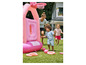 Des enfants jouent avec un château gonflable rose avec un panier de basket-ball et des anneaux.