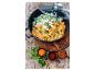 Curry de poulet avec riz, coriandre et épices dans une cocotte ELO sur une planche en bois.