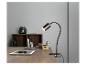 Une lampe de bureau flexible noire avec une tablette sur un bureau en bois.